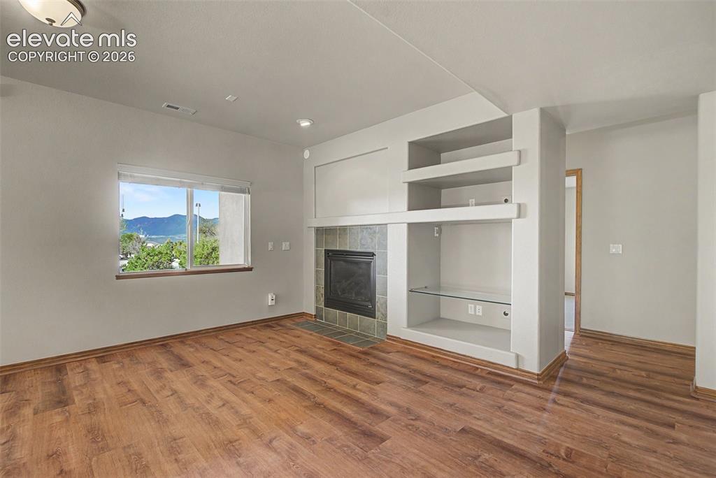 Image 34 of 50: Large family room is basement with fireplace