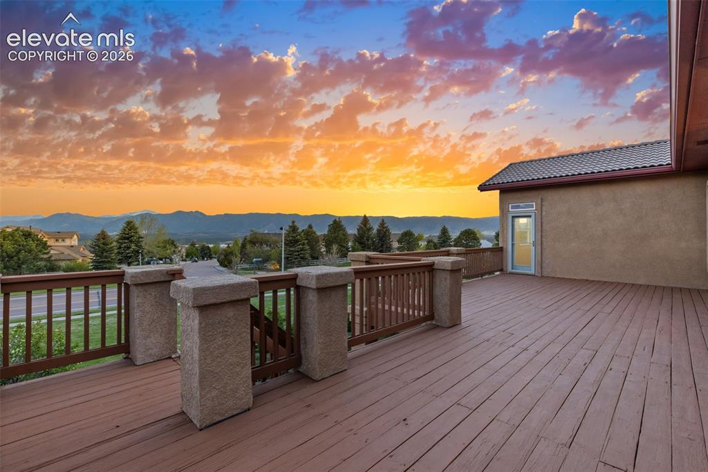 Image 4 of 50: Expansive wood deck with views of Pikes Peak, Front Range, and USAFA