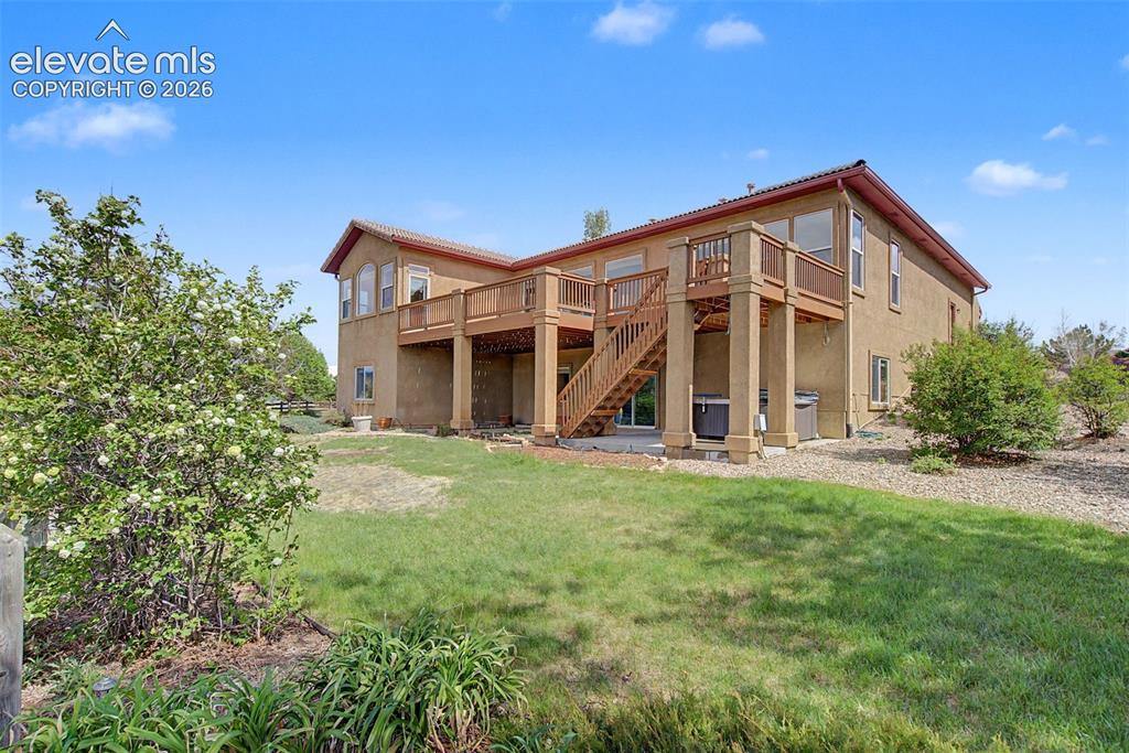 Image 7 of 50: Backyard has lots of space and mature landscape