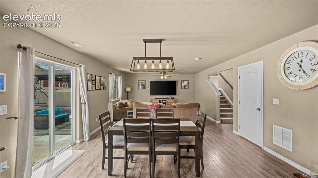 Image 14 of 41: Open-concept living space featuring wood-finish flooring, a modern linear c