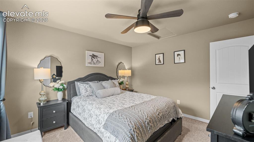Image 21 of 41: Carpeted room featuring a ceiling fan with integrated lighting, a paneled d
