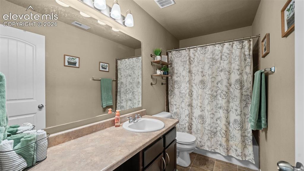 Image 22 of 41: Bathroom featuring a vanity with an integrated sink, broad countertop, and
