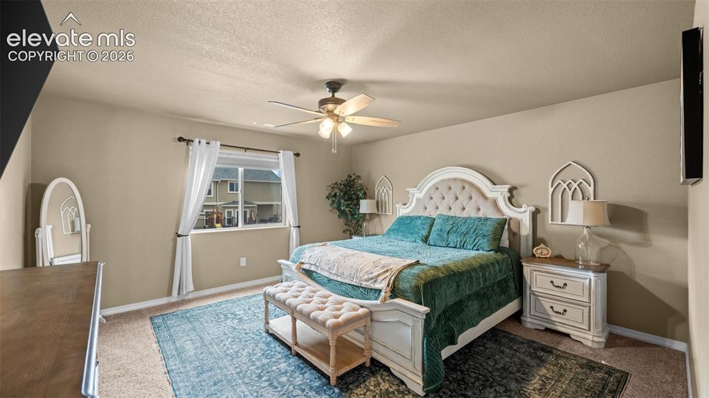 Image 24 of 41: Spacious room featuring carpeting, neutral-toned walls, and a ceiling fan w