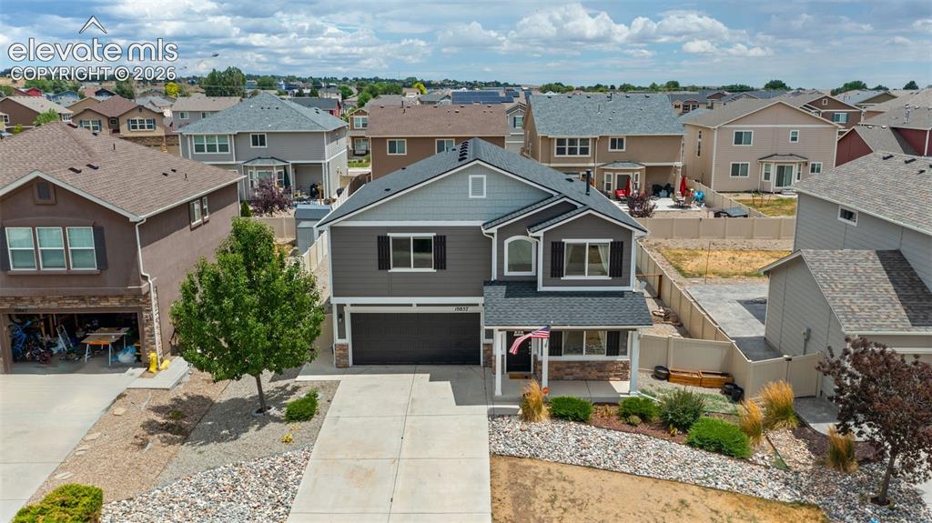 Image 33 of 41: Modern two-story residence featuring a gray and light blue siding exterior,
