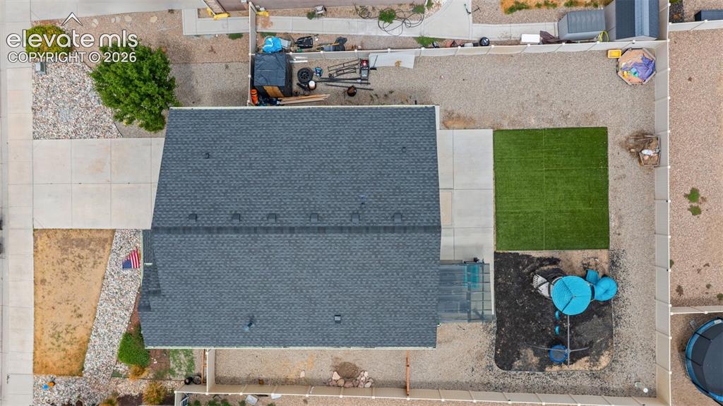 Image 38 of 41: Asphalt shingle roof with a partial concrete driveway