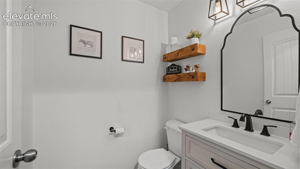 Image 6 of 41: Bathroom featuring a vanity with a white countertop and undermount sink, ma
