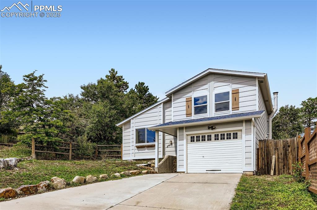 Caption: Traditional home featuring driveway and an attached garage