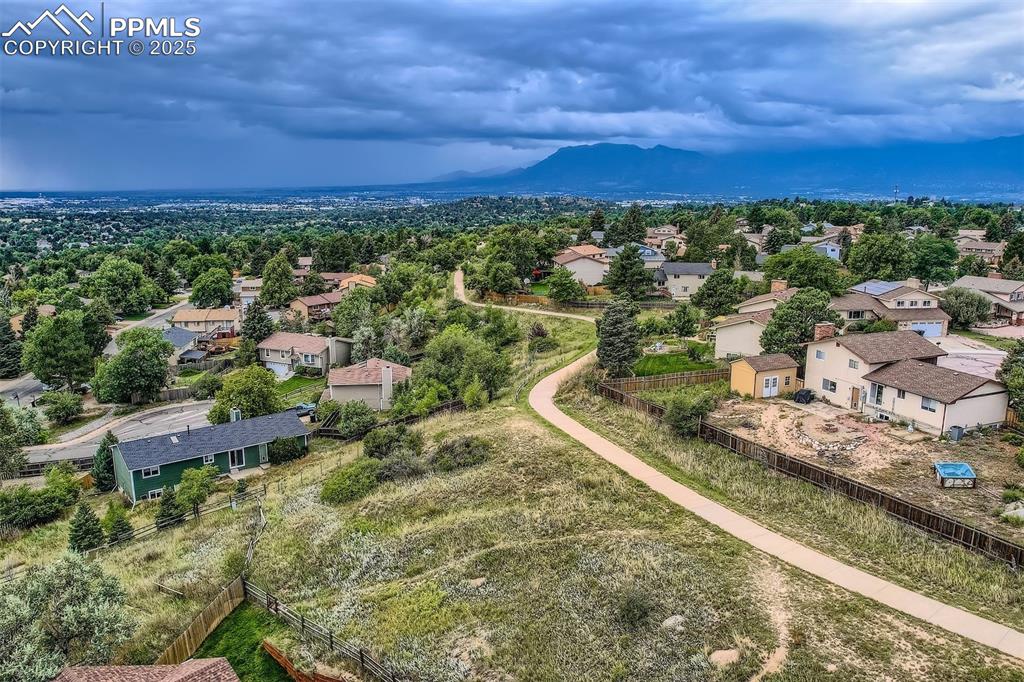 Image 36 of 45: Aerial perspective of suburban area featuring a mountainous background