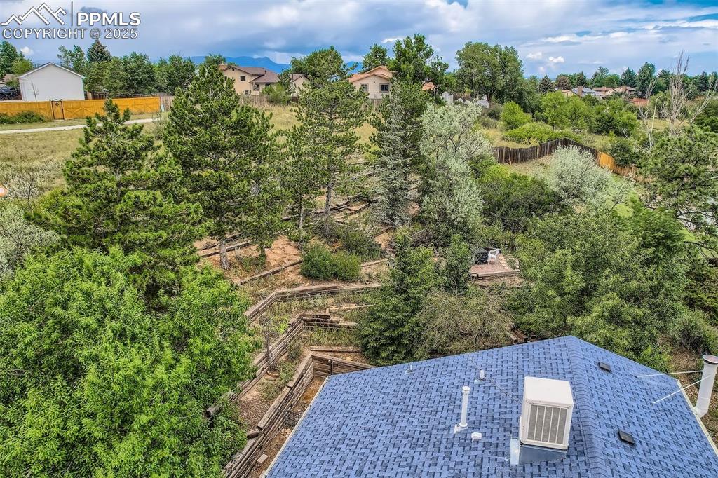 Image 37 of 45: Aerial view of a tree filled landscape.