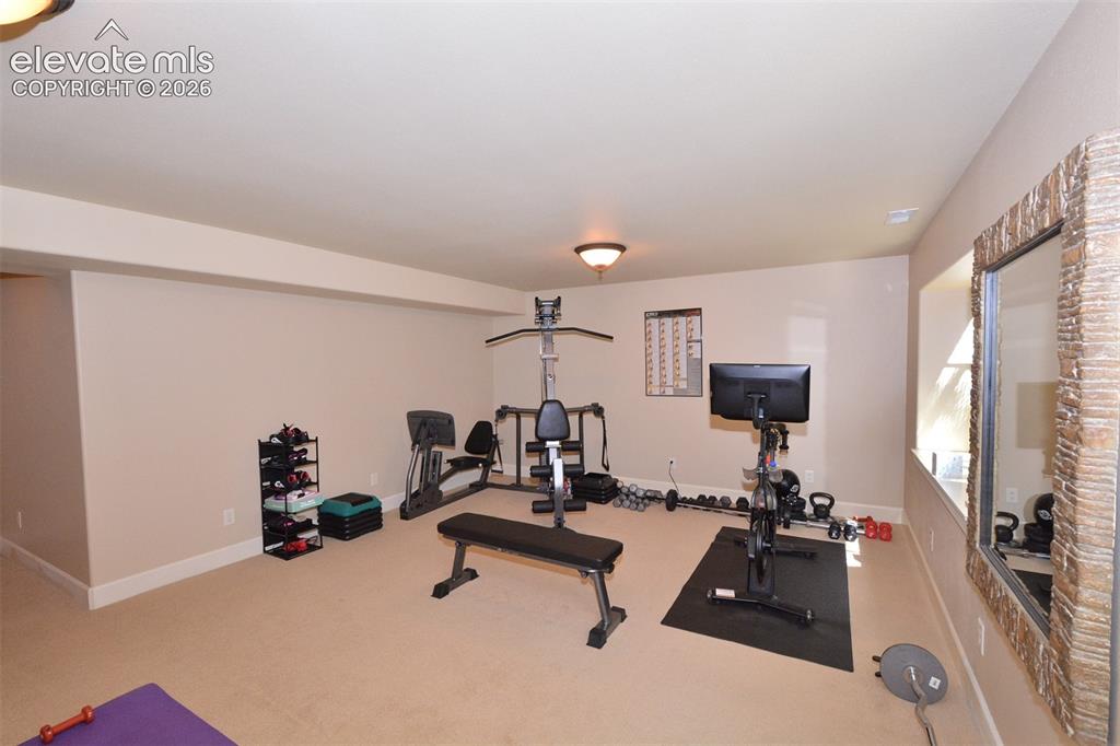 Image 10 of 31: Junior suite in basement - currently being used as an exercise room