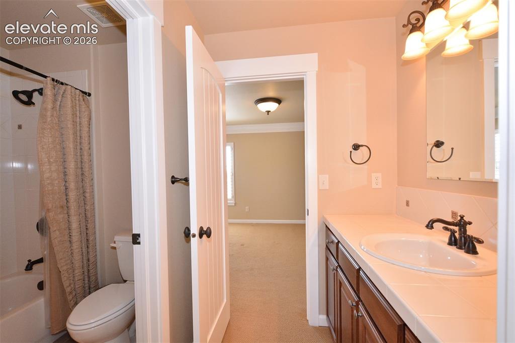 Image 18 of 31: Upper level full bathroom with