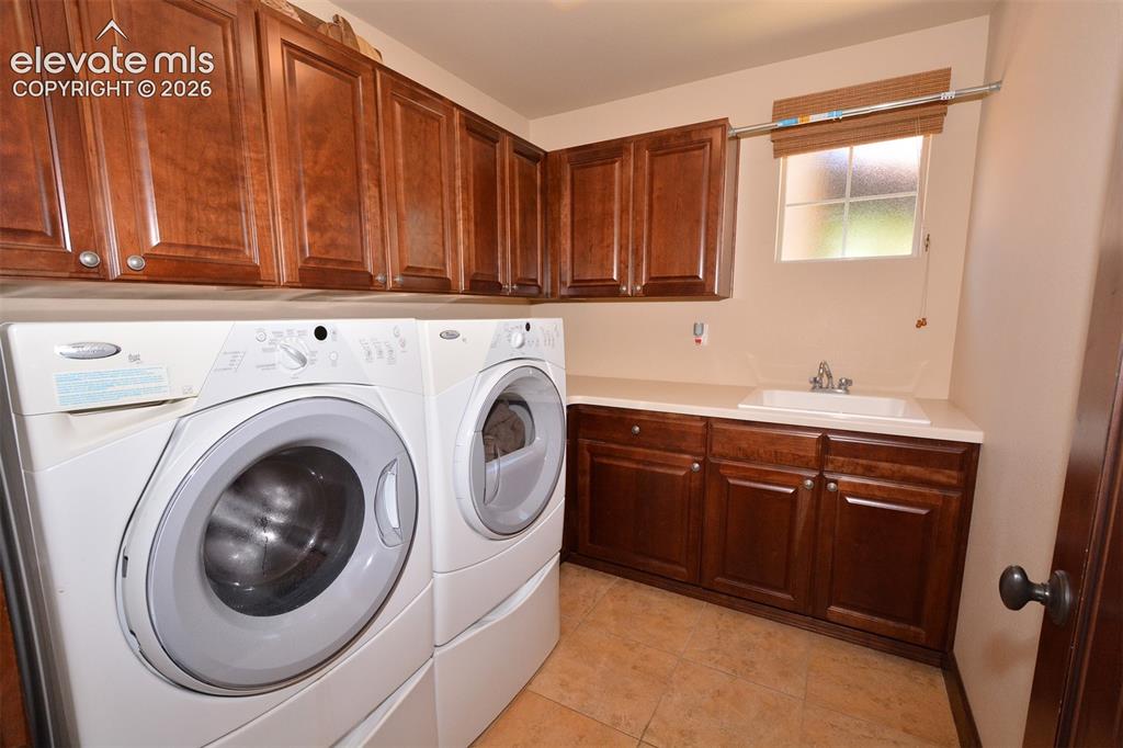 Image 20 of 31: Laundry room on main level with utility sink