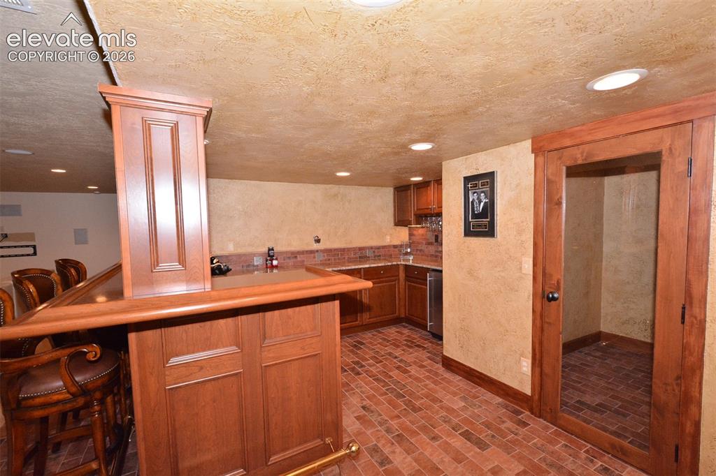 Image 8 of 31: Irish pub style wet bar & wine cellar