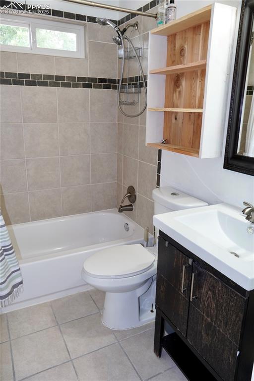 Image 5 of 23: Bathroom with shower / bath combo, vanity, and light tile patterned floorin