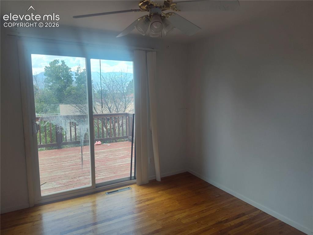 Image 15 of 18: bedroom on upper-level w/walk-out deck