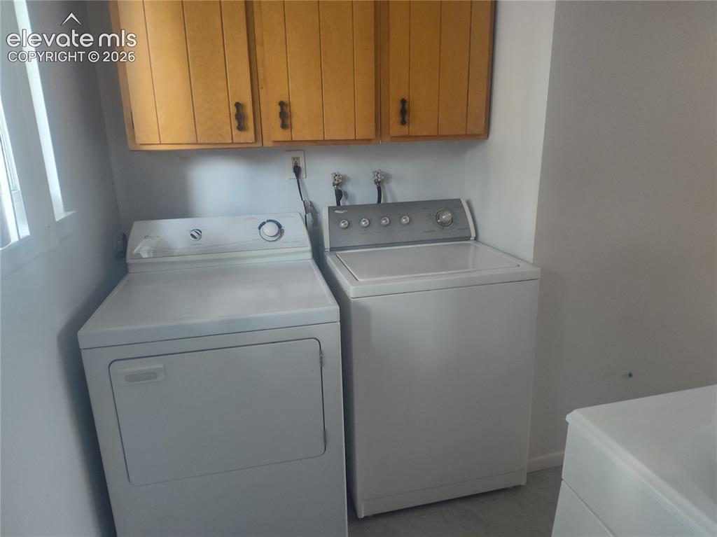 Image 9 of 18: Laundry space on lower level