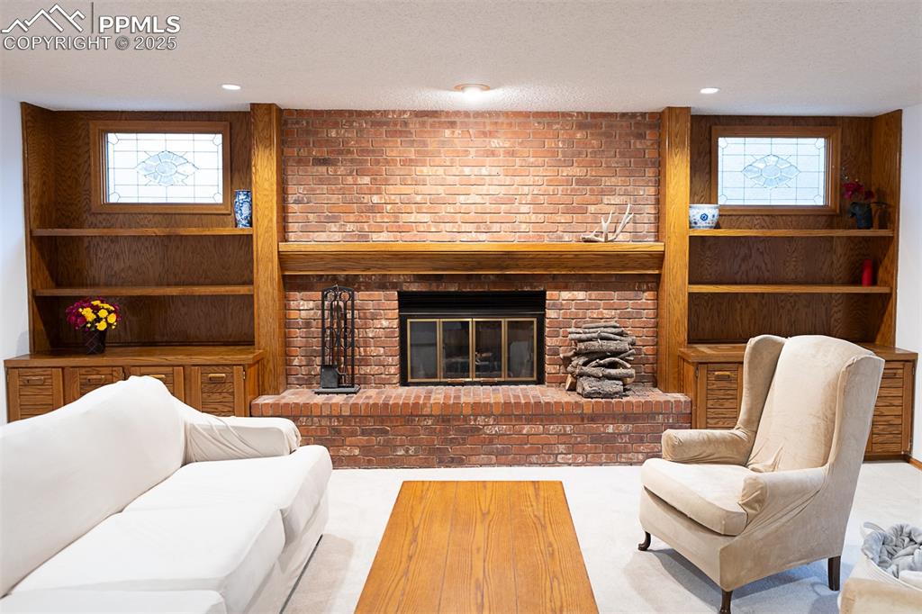 Image 11 of 47: Built ins surround the fireplace.