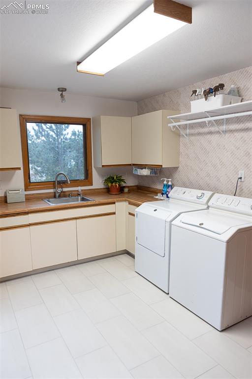 Image 23 of 47: Large laundry room with garage and deck access.