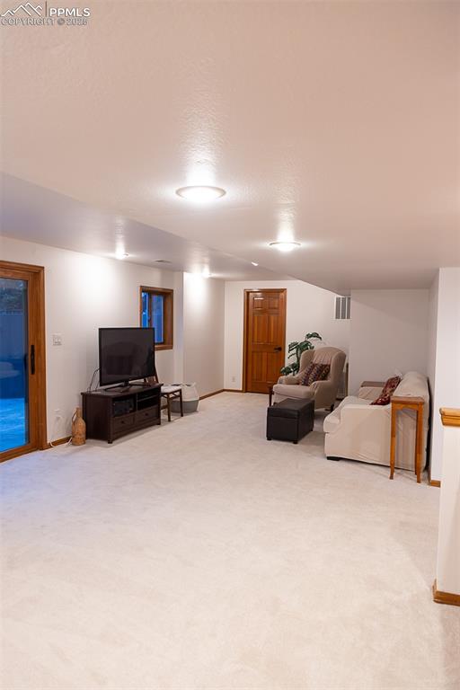 Image 29 of 47: Large living room in walkout basement.