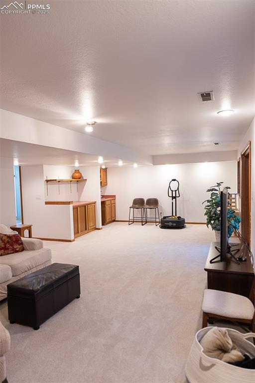Image 31 of 47: Large living room in walkout basement.