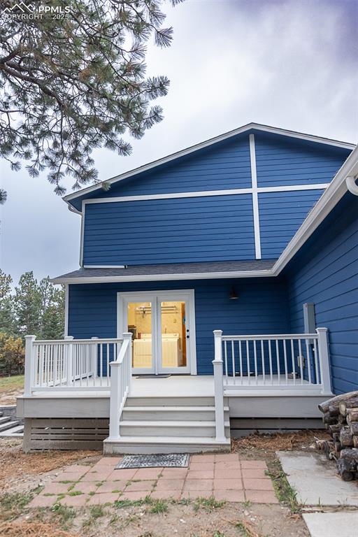 Image 44 of 47: Composite deck on side of home with access to laundry / mud room.