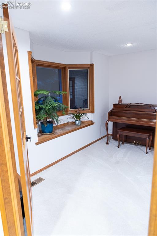 Image 6 of 47: French doors off the foyer lead to a bedroom, currently being used as an of