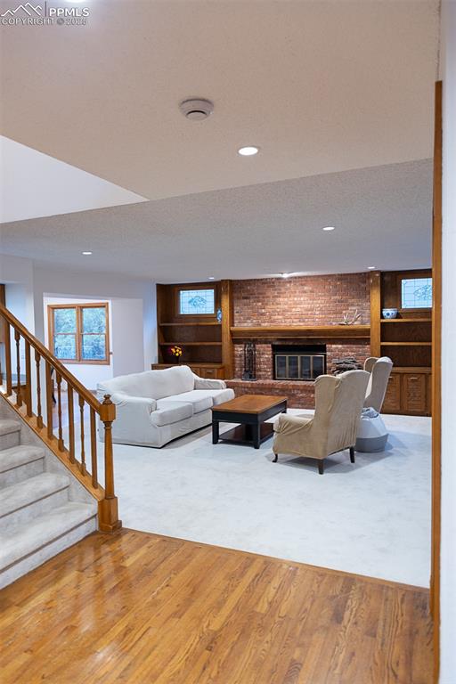 Image 8 of 47: Living room with a wood burning fireplace.