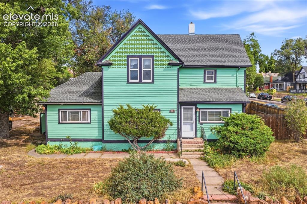 Caption: Two-story exterior with horizontal siding and a patterned gable accent