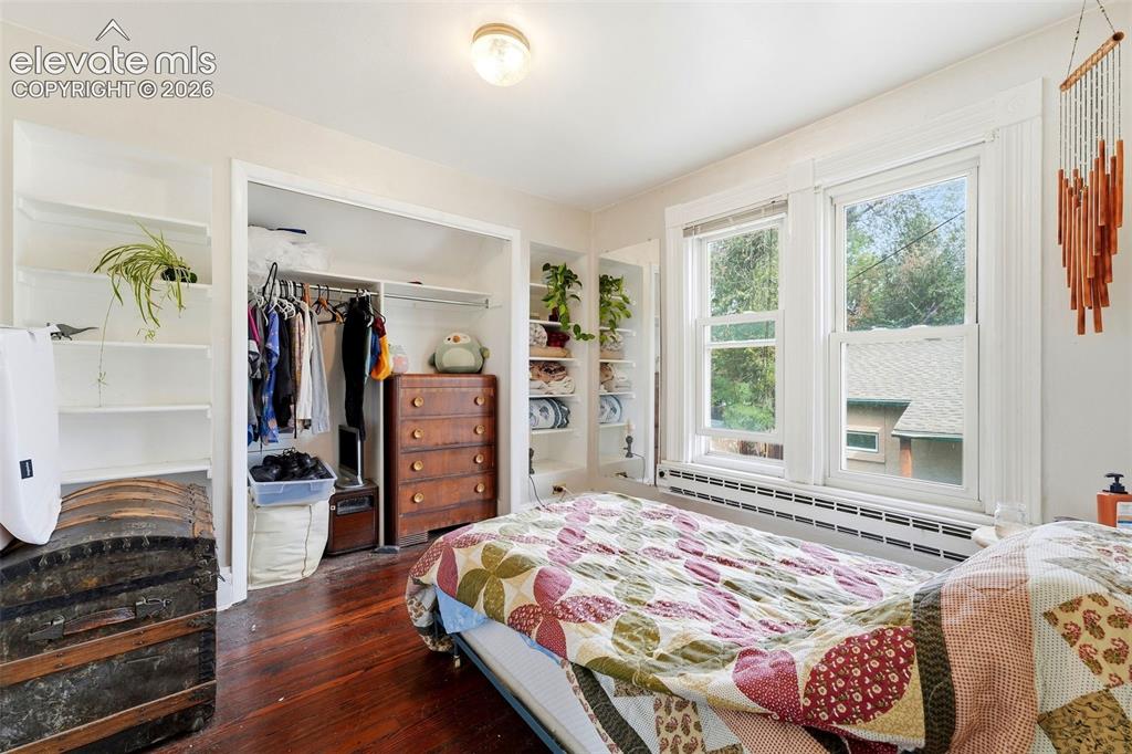 Image 22 of 35: Wood-finish flooring, built-in shelving, dual windows, and an integrated cl