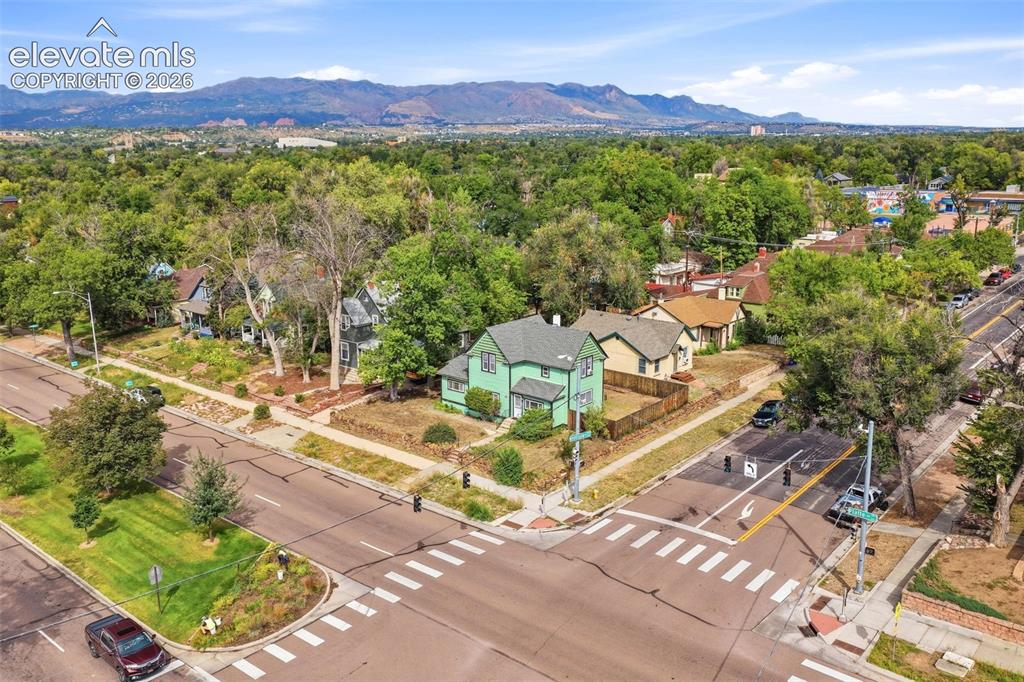 Image 33 of 35: Corner lot property with a fenced backyard and established trees