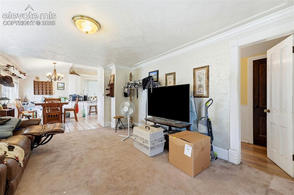 Image 8 of 35: Recessed lighting, crown molding, and an open doorway to the dining area