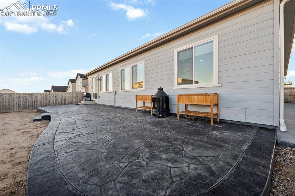Image 32 of 35: Extended Stamped Concrete runs the width of the house