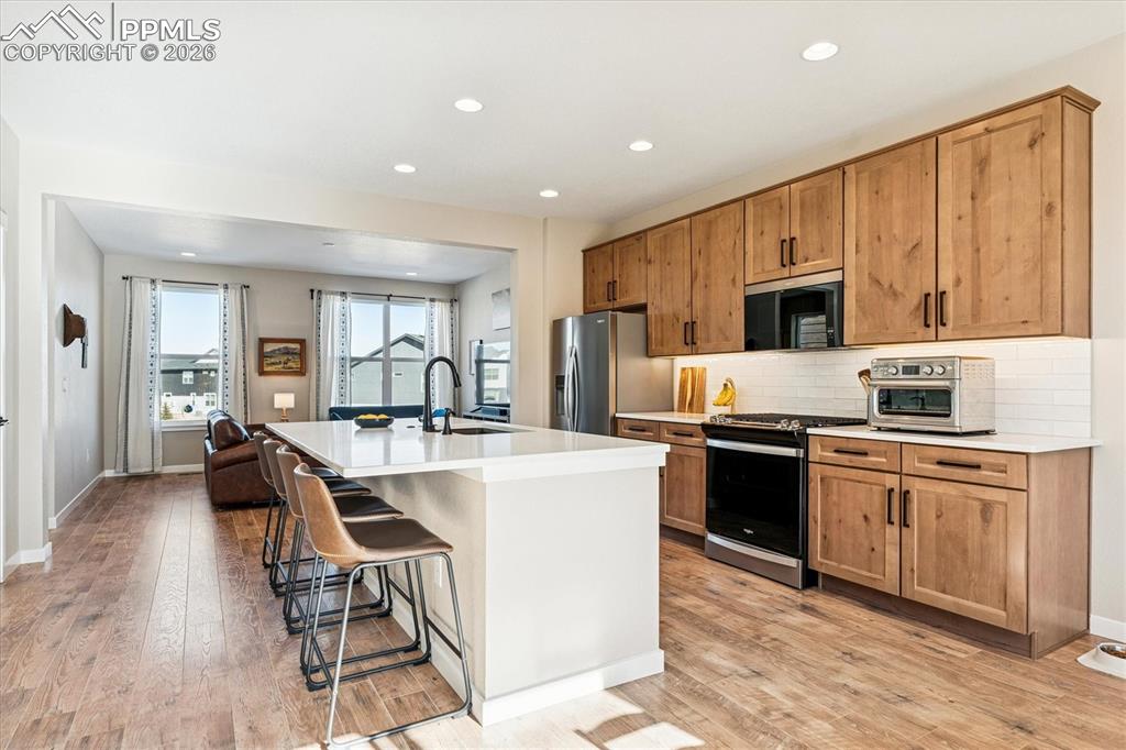 Image 4 of 22: Kitchen with Upgraded Cabinetry & Walk-In Pantry