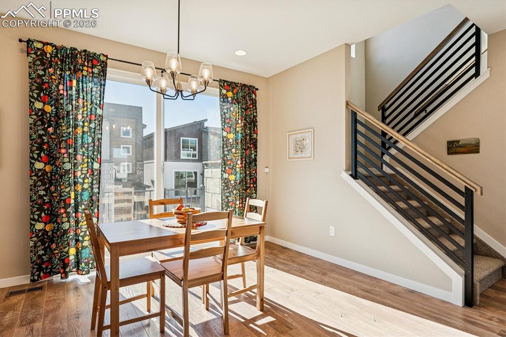 Image 9 of 22: Spacious Dining Room with Laminate Flooring