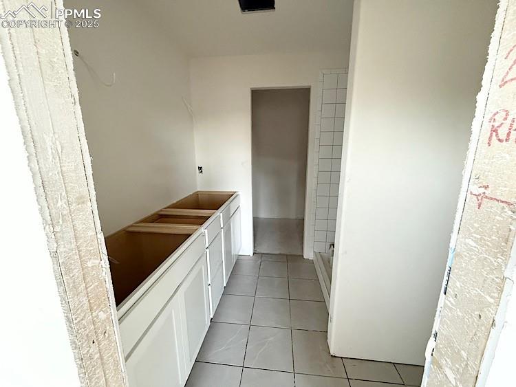 Image 18 of 29: Primary bathroom and walk-in closet with wood shelving and rods! Please, ex