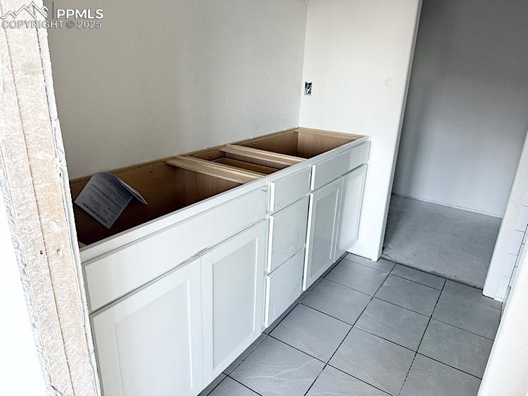 Image 19 of 29: Primary bathroom and walk-in closet with wood shelving and rods! Please, ex