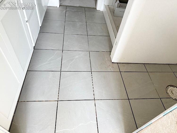 Image 20 of 29: Primary bathroom and walk-in closet with wood shelving and rods! Please, ex