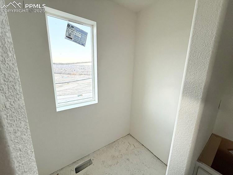 Image 24 of 29: Upper Level Bedroom walk-in closet. Please, excuse our dust as this home is
