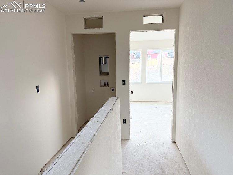 Image 27 of 29: Hallway at upper level. Please, excuse our dust as this home is currently u