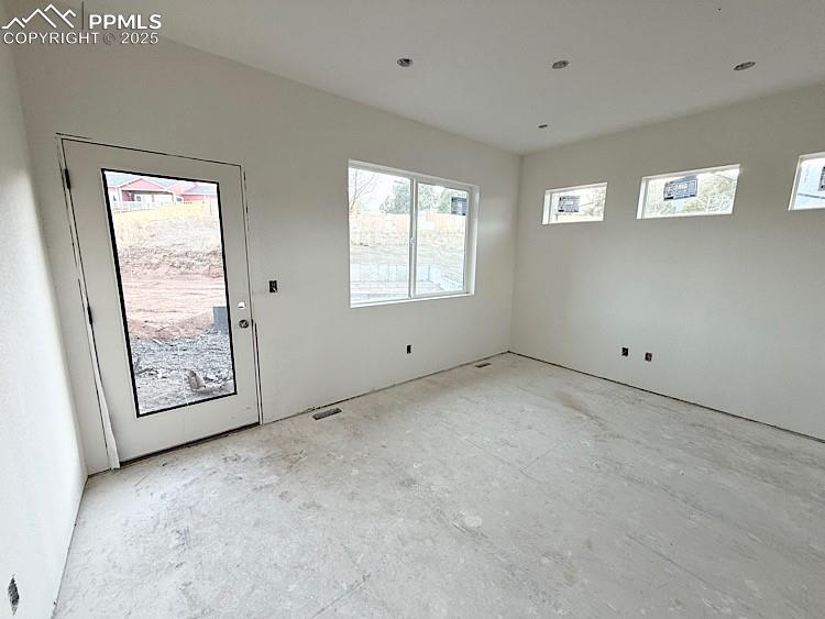Image 9 of 29: Living Room with Door to rear patio.  Please, excuse our dust as this home 