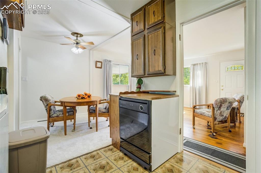 Image 15 of 47: Kitchen featuring dishwasher, ceiling fan, and brown cabinetry