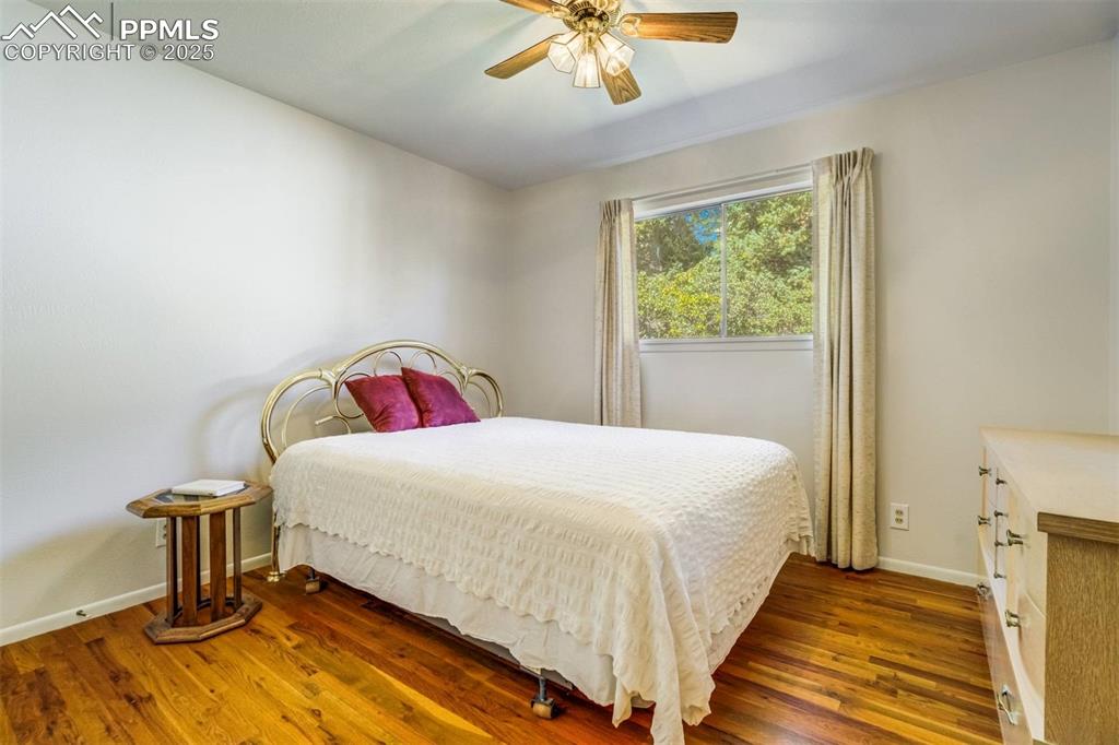 Image 16 of 47: Bedroom featuring wood finished floors and a ceiling fan
