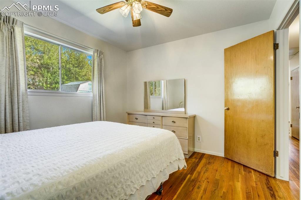 Image 17 of 47: Bedroom featuring wood finished floors and ceiling fan