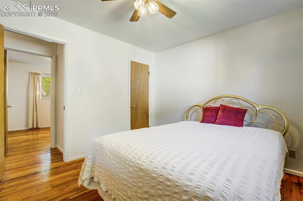 Image 18 of 47: Bedroom featuring wood finished floors and ceiling fan