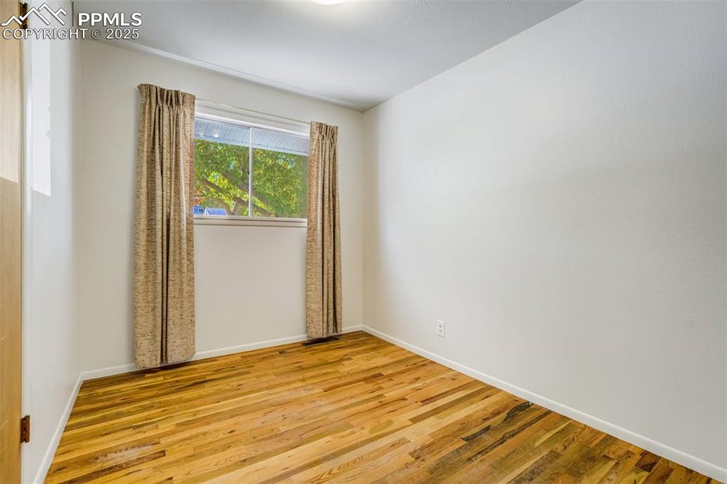 Image 20 of 47: Unfurnished room with light wood-style floors and baseboards