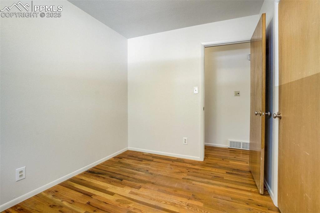 Image 22 of 47: Unfurnished room with light wood-type flooring and baseboards