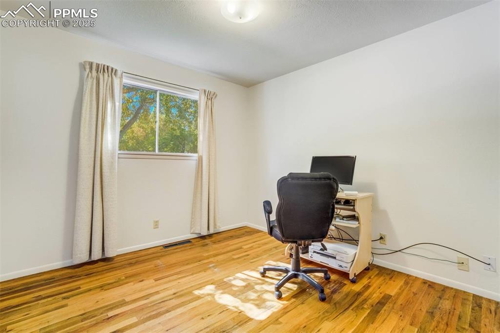 Image 23 of 47: Office space featuring baseboards and light wood-style flooring