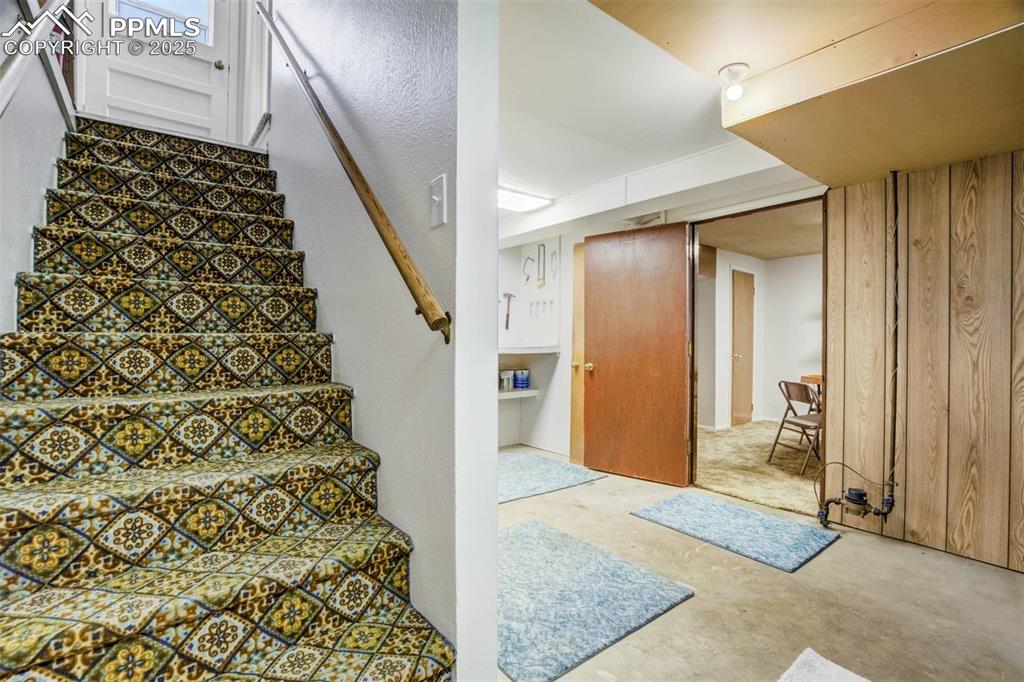 Image 26 of 47: Stairs featuring concrete flooring