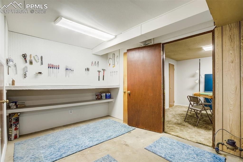 Image 27 of 47: Miscellaneous room with concrete floors