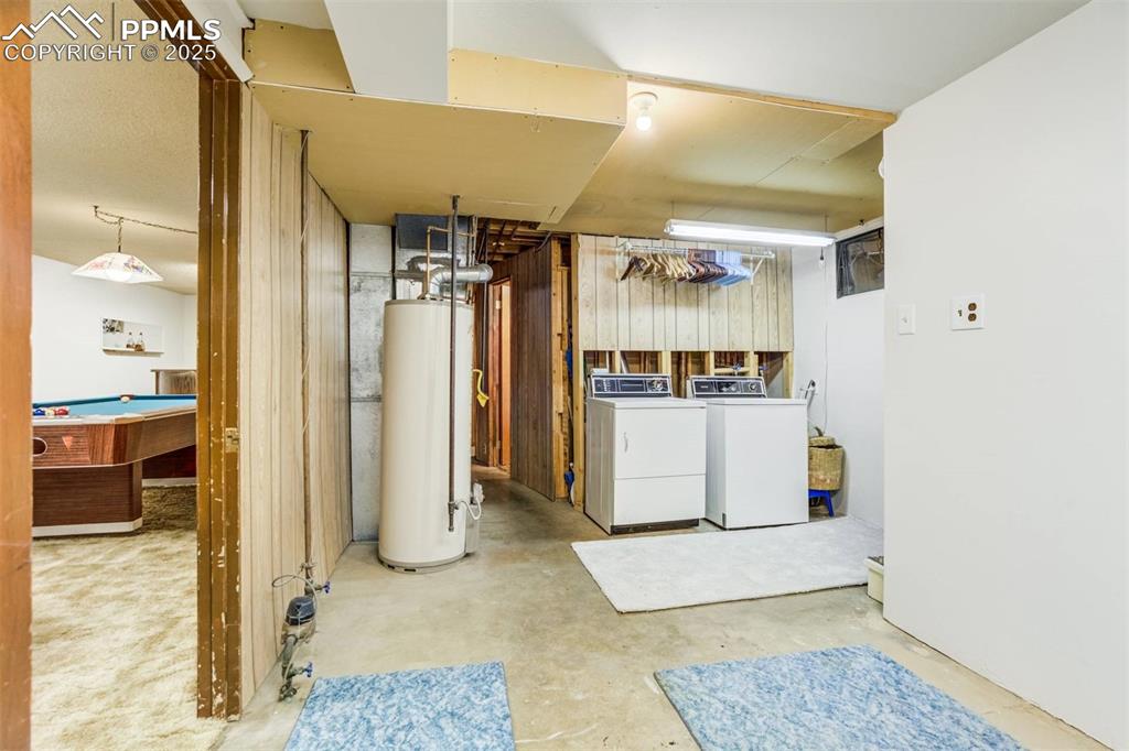 Image 29 of 47: Finished below grade area featuring washing machine and clothes dryer, wate